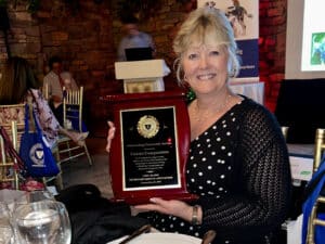 Woman holding award plaque