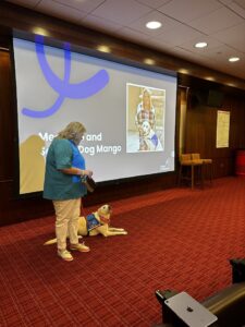 Canine Companions client Deb speaks with Chiefs staff.