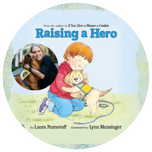Cover of the children's book 'Raising a Hero' featuring a young boy with reddish-brown hair hugging a small yellow dog wearing a service vest, with a background illustration of a light blue sky. The text at the top states 'From the author of If You Give a Mouse a Cookie' and includes the names of the author Laura Numeroff and illustrator Lynn Munsinger.